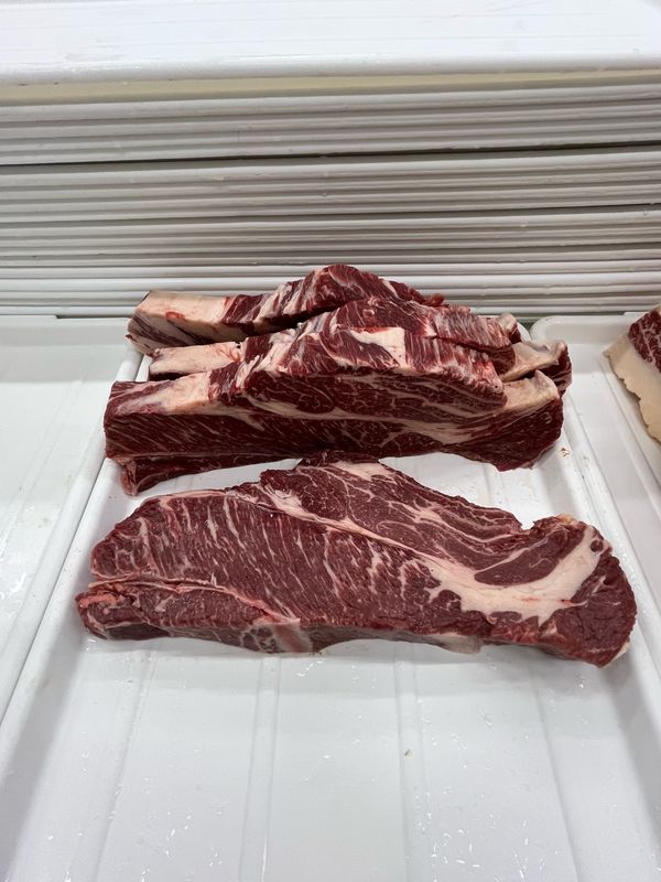 Akaushi Wagyu short ribs, bone-in, laid out on paper