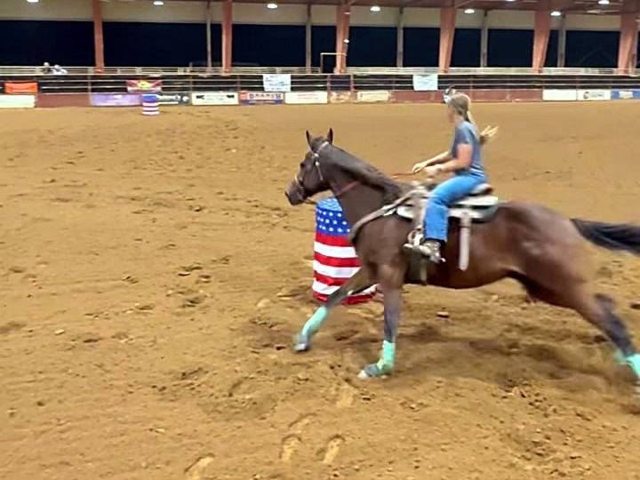 Adeline Frost turning a barrel on Ditto, a bay horse