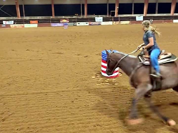 Adeline Frost rounding a barrel on Pepper, a red roan